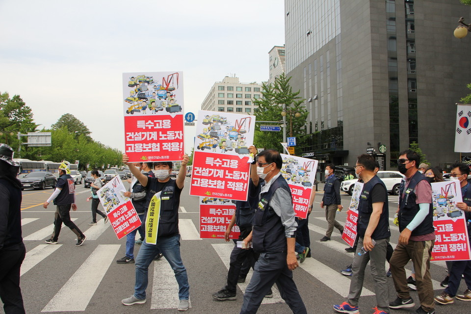 노조법 2조 개정・고용보험 적용 직접행동에 참가한 건설기계노동자들이 국회 앞 1인 시위를 진행하기 위해 이동하고 있다.